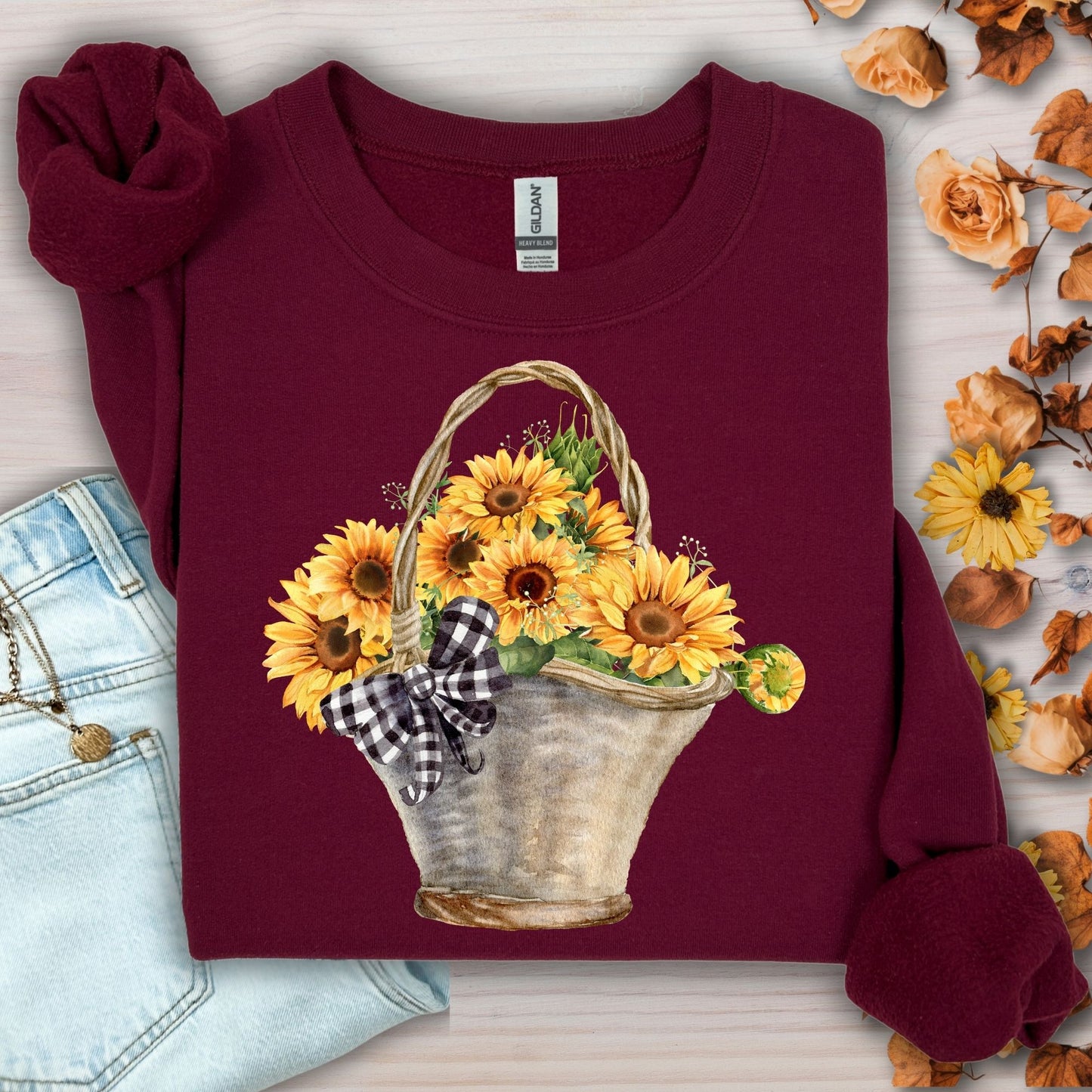 Maroon Gildan sweatshirt with a watercolor basket of golden sunflowers and a black-and-white checkered bow.