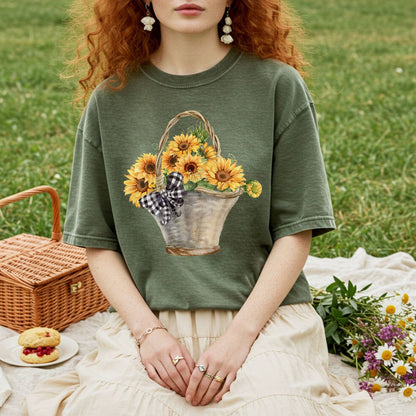 Relaxed-fit, garment-dyed olive green t-shirt with a hand-painted basket of sunflowers and gingham bow.