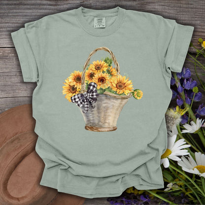 Bay S t-shirt with a hand-painted watercolor basket of sunflowers and a gingham bow.
