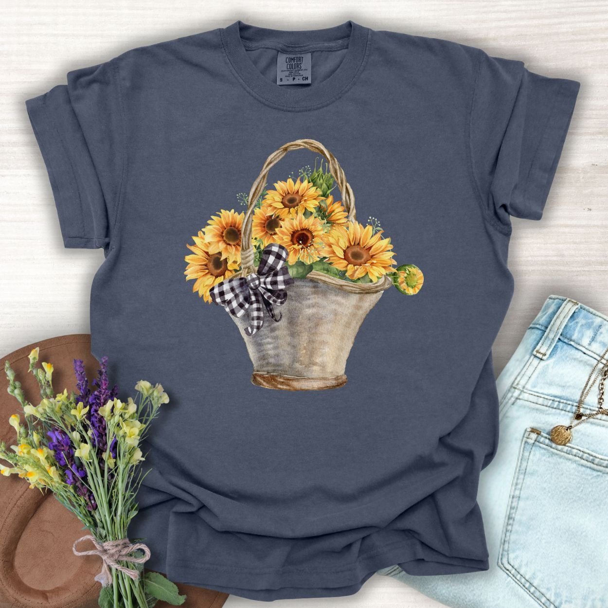 Denim S t-shirt with a hand-painted watercolor basket of sunflowers and a gingham bow.