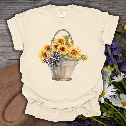Ivory S t-shirt with a hand-painted watercolor basket of sunflowers and a gingham bow.