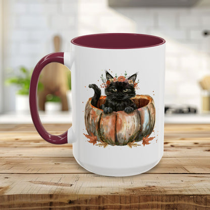 White ceramic mug with a black kitten in a pumpkin, burgundy handle and interior.