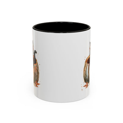 White ceramic mug with black interior and handle, featuring a watercolor black kitten in a pumpkin design.