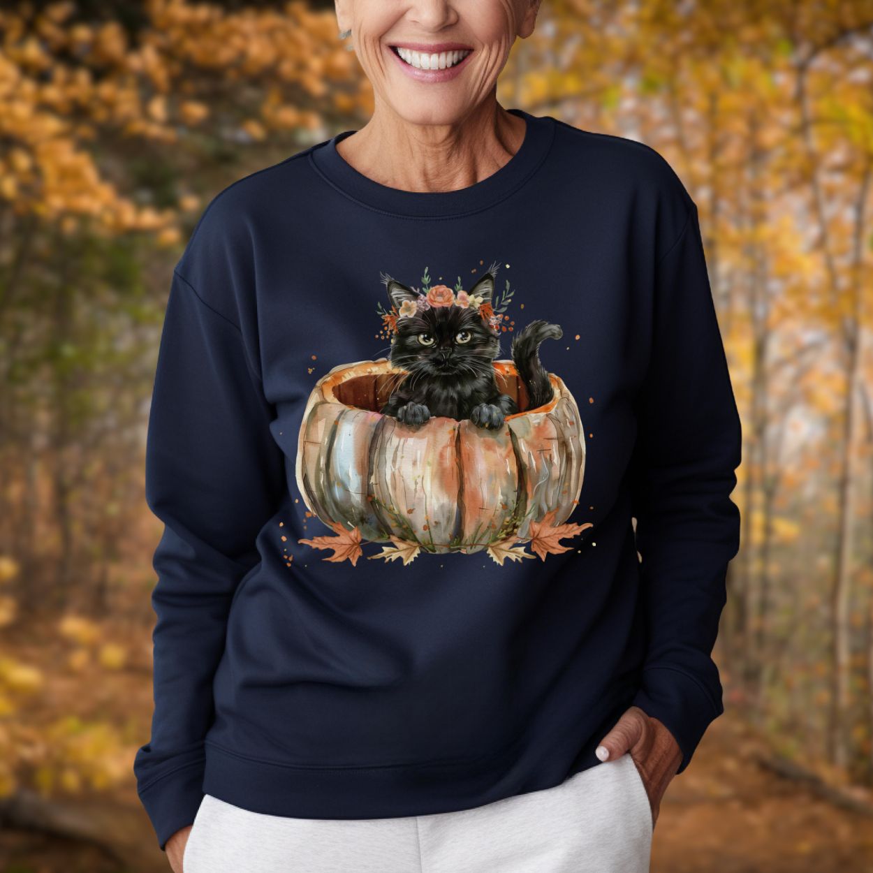 Navy blue Gildan 18000 sweatshirt with a watercolor black cat in a pumpkin and autumn flowers.