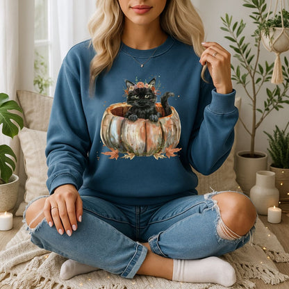 Woman in a blue Gildan 18000 sweatshirt with a black boho kitten in pumpkin watercolor design.