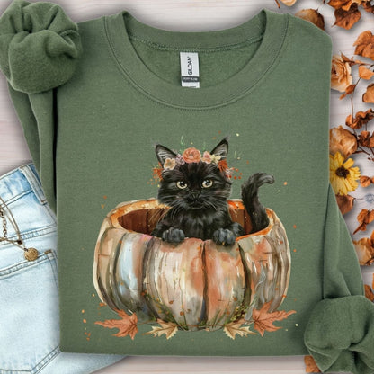 Military Green Gildan sweatshirt with a watercolor black cat in a pumpkin, surrounded by autumn flowers.