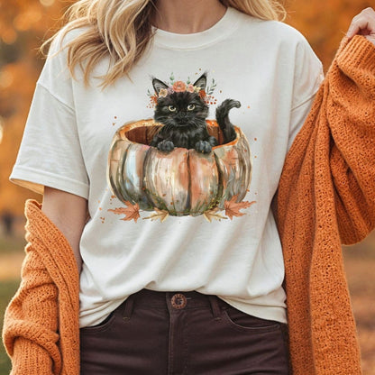 White Comfort Colors t-shirt with a watercolor black cat in a pumpkin and autumn flowers.