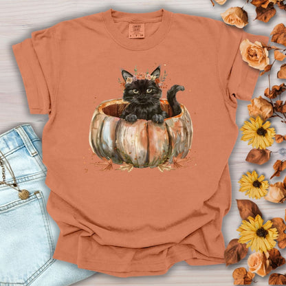 Yam Comfort Colors t-shirt with a watercolor black cat in a pumpkin surrounded by autumn flowers.