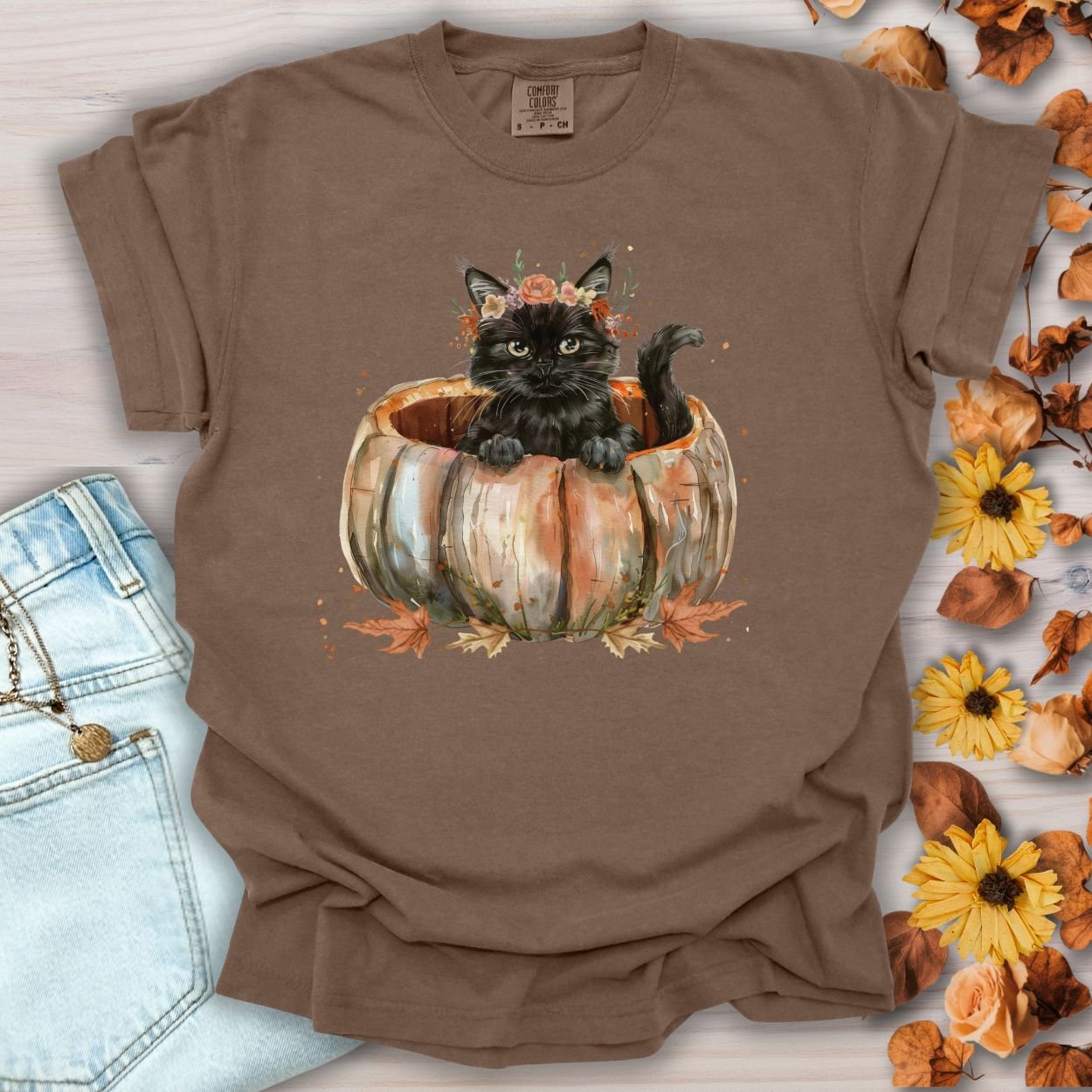 Espresso Comfort Colors t-shirt with a watercolor black cat in a pumpkin and autumn flowers.