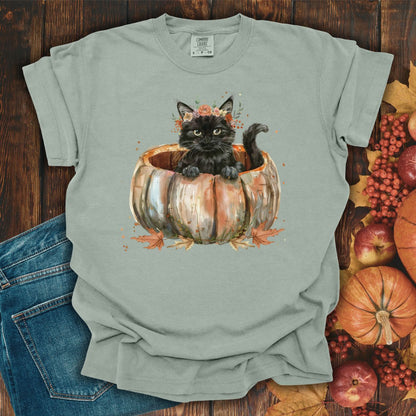 Bay Comfort Colors t-shirt with a watercolor black cat in a pumpkin surrounded by autumn flowers.