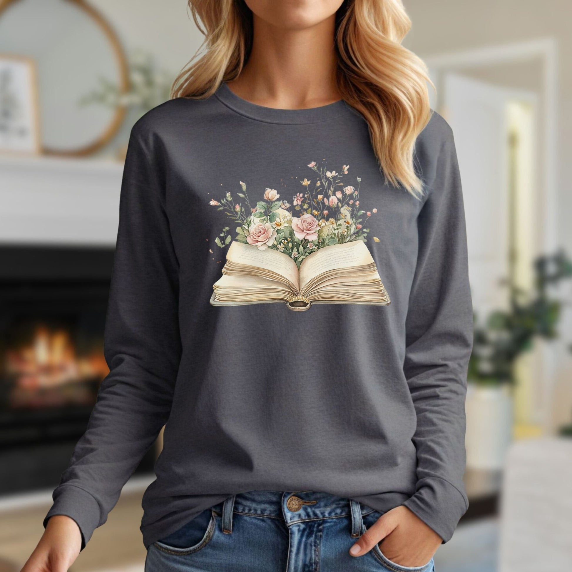 Gray long-sleeve tee with a whimsical illustration of an open vintage book blooming with watercolor roses and wildflowers.