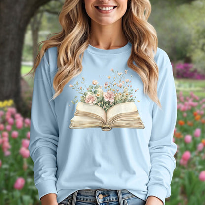 Light blue long sleeve tee with an open vintage book design blooming with pink roses and wildflowers.