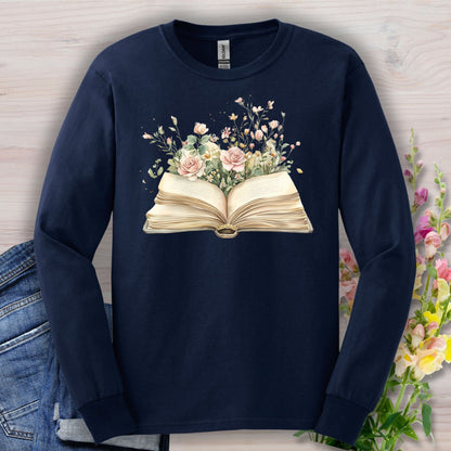 Navy long sleeve tee with an open vintage book design blooming with watercolor roses and wildflowers.