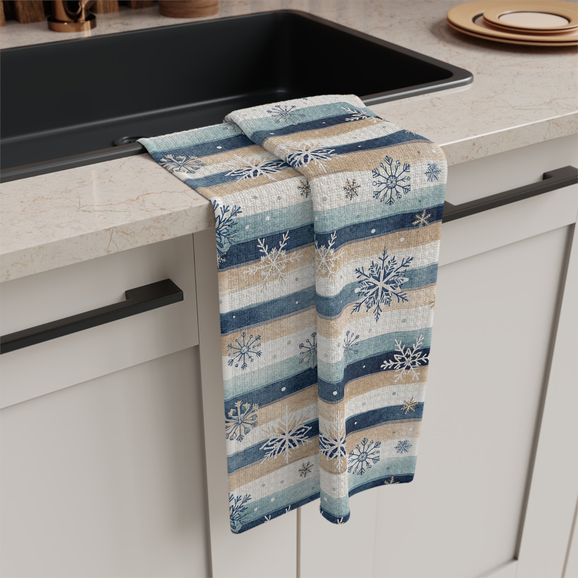 Blue boho snowflake stripe microfiber tea towel with muted navy, cream, and beige stripes, draped over a kitchen counter.