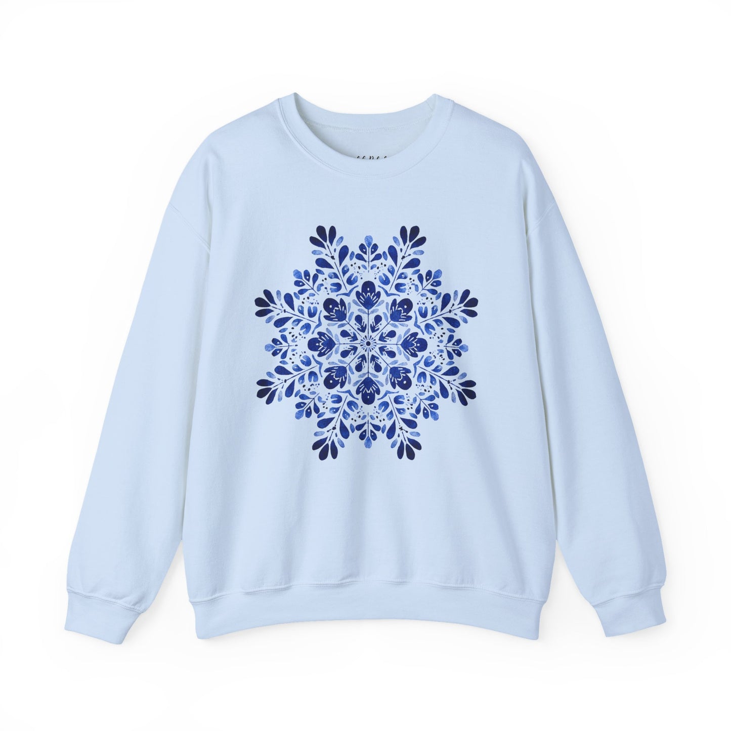White crewneck sweatshirt with a blue folk art floral snowflake medallion design.