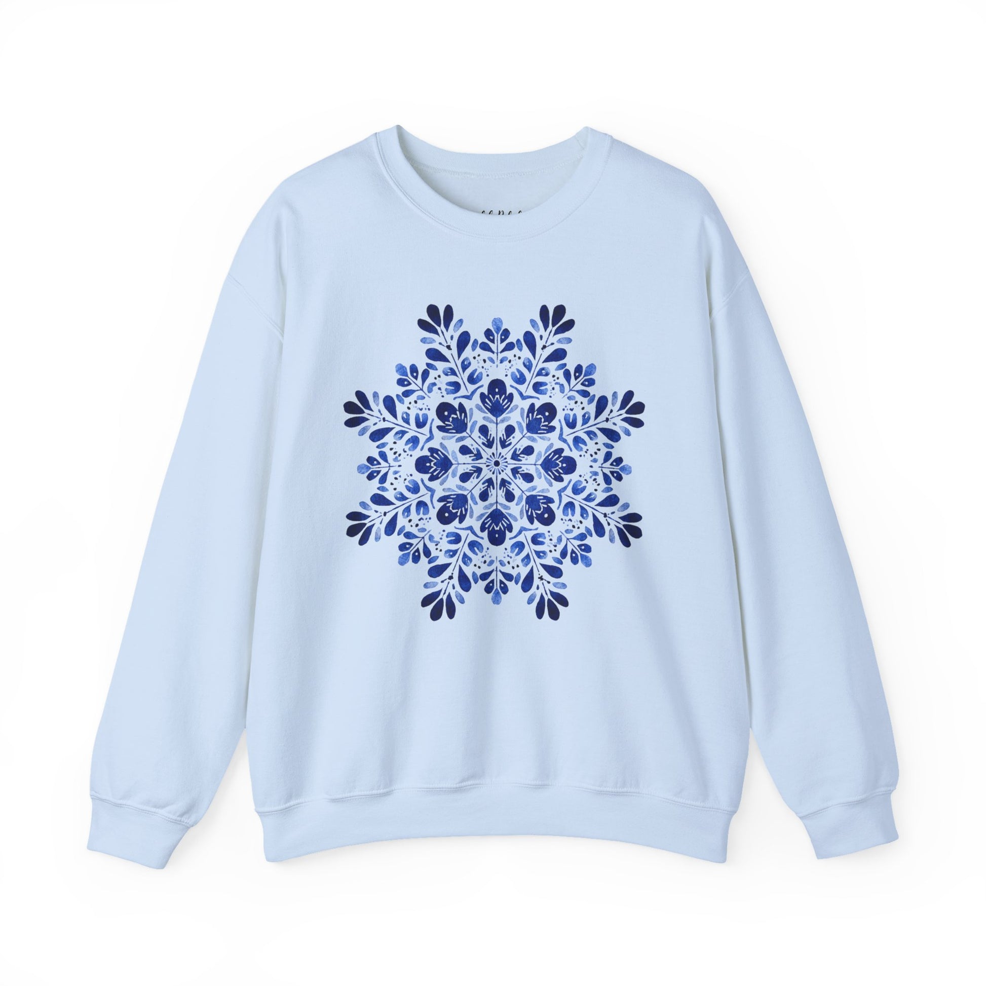 White crewneck sweatshirt with a blue folk art floral snowflake medallion design.