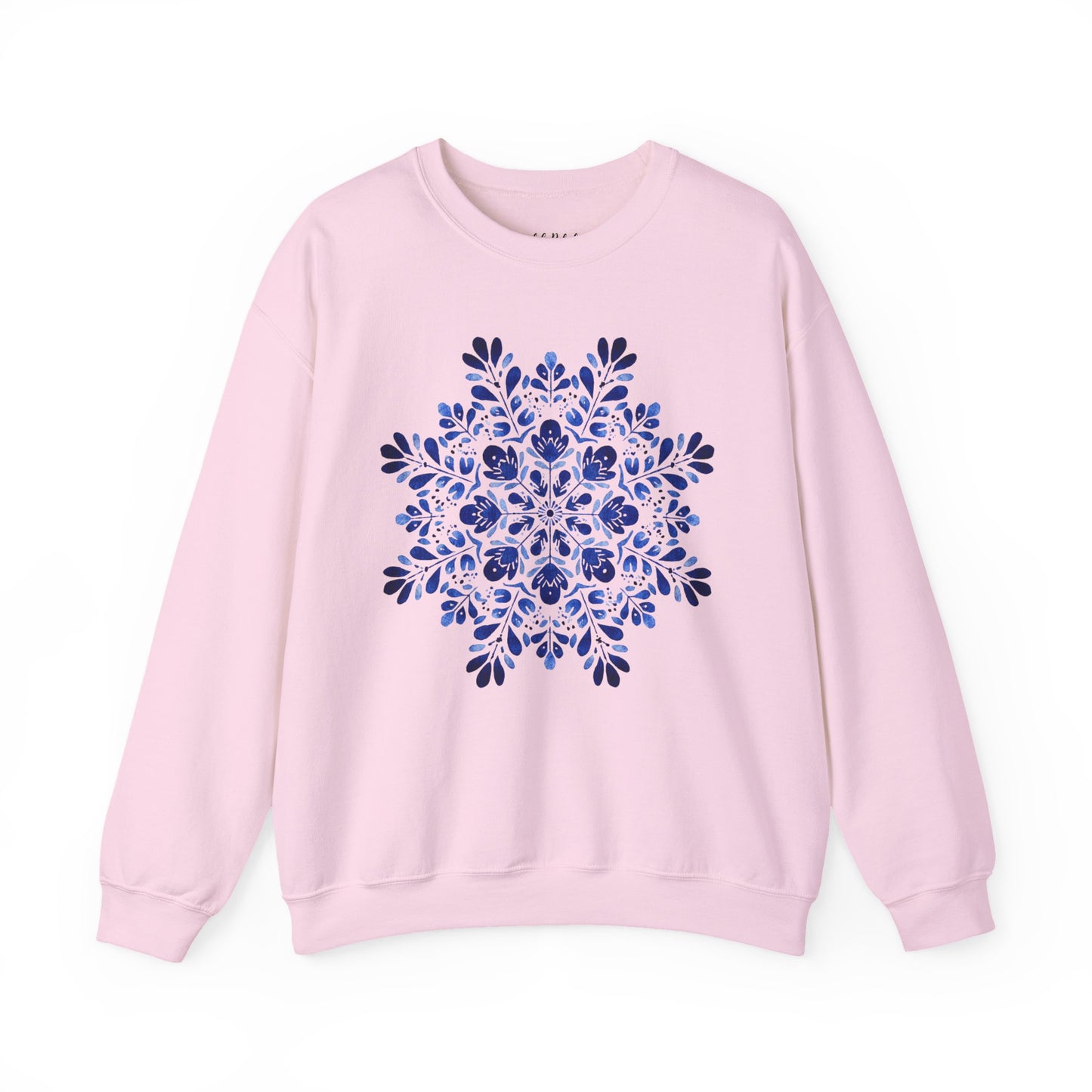 Pink crewneck sweatshirt with a large blue floral folk art snowflake design at the center.