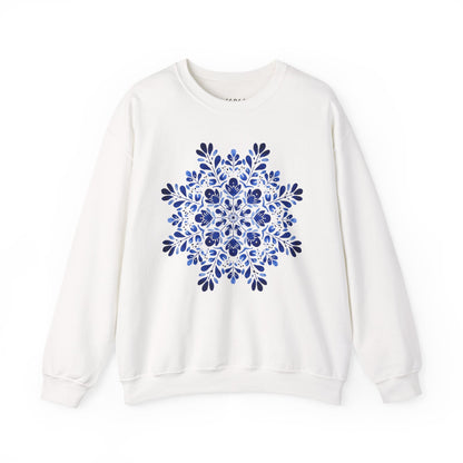 White crewneck sweatshirt with a symmetrical blue folk art floral snowflake design.