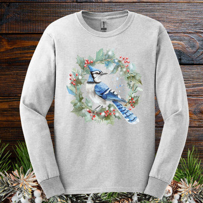 Ash long sleeve tee with a watercolor blue jay in a holly wreath design.