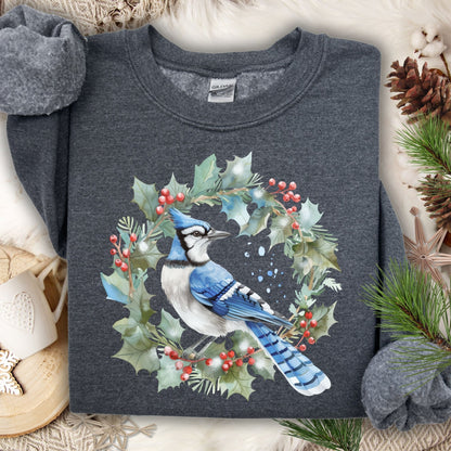 Dark gray Gildan 18000 sweatshirt with a watercolor blue jay in a holly wreath design.