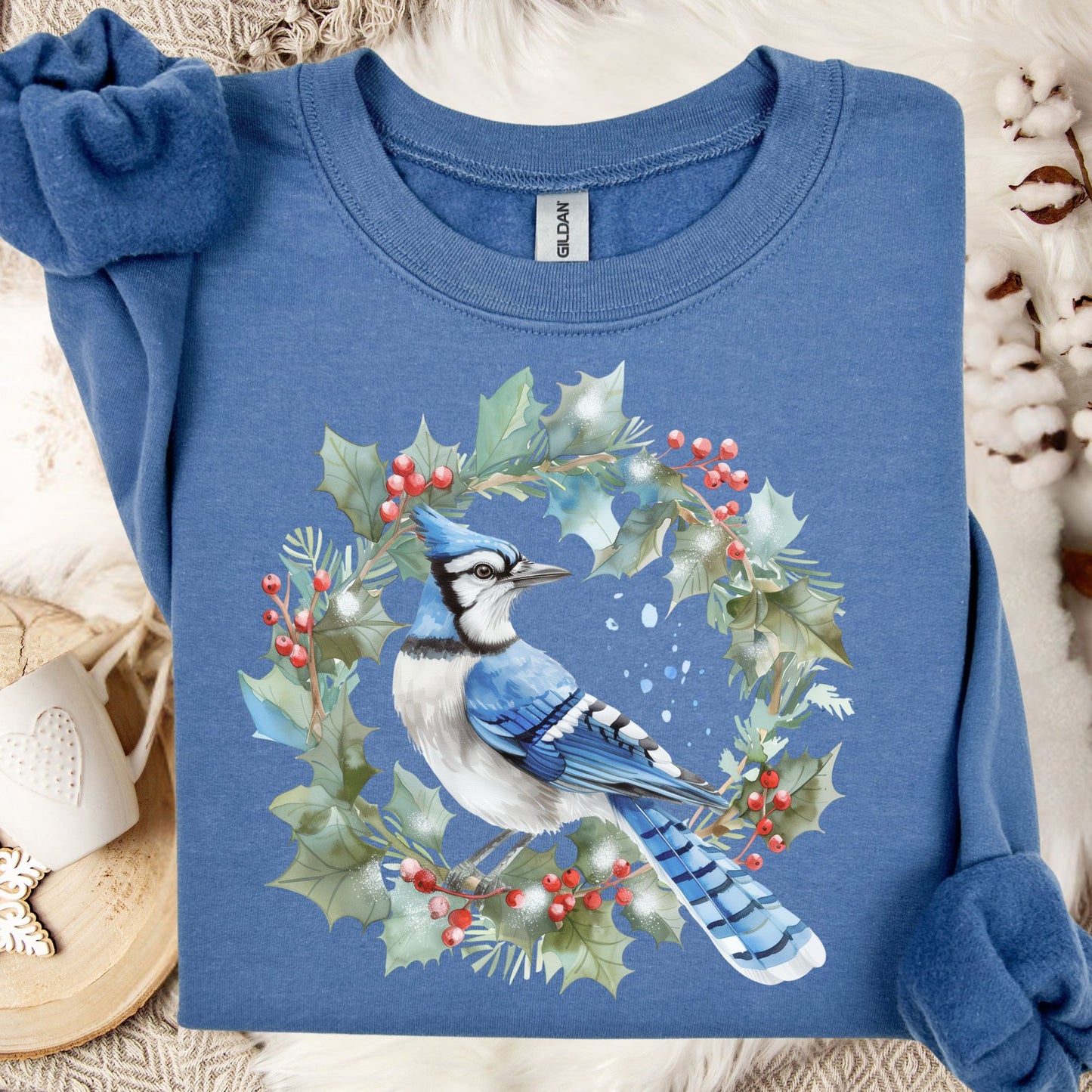 Indigo Blue Gildan 18000 sweatshirt with a watercolor blue jay in a holly wreath design.
