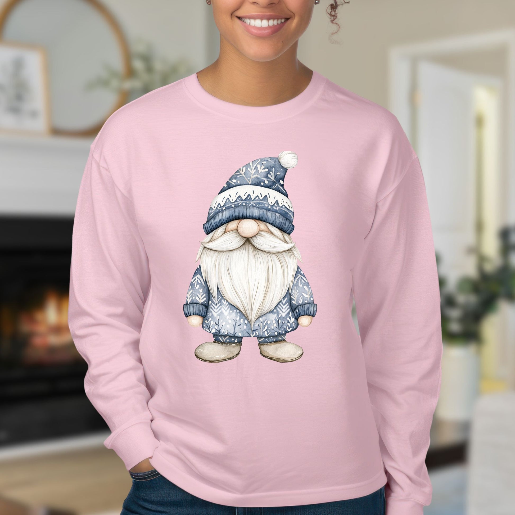 Woman wearing a pink long-sleeve tee with a hand-illustrated blue Nordic gnome on the chest.