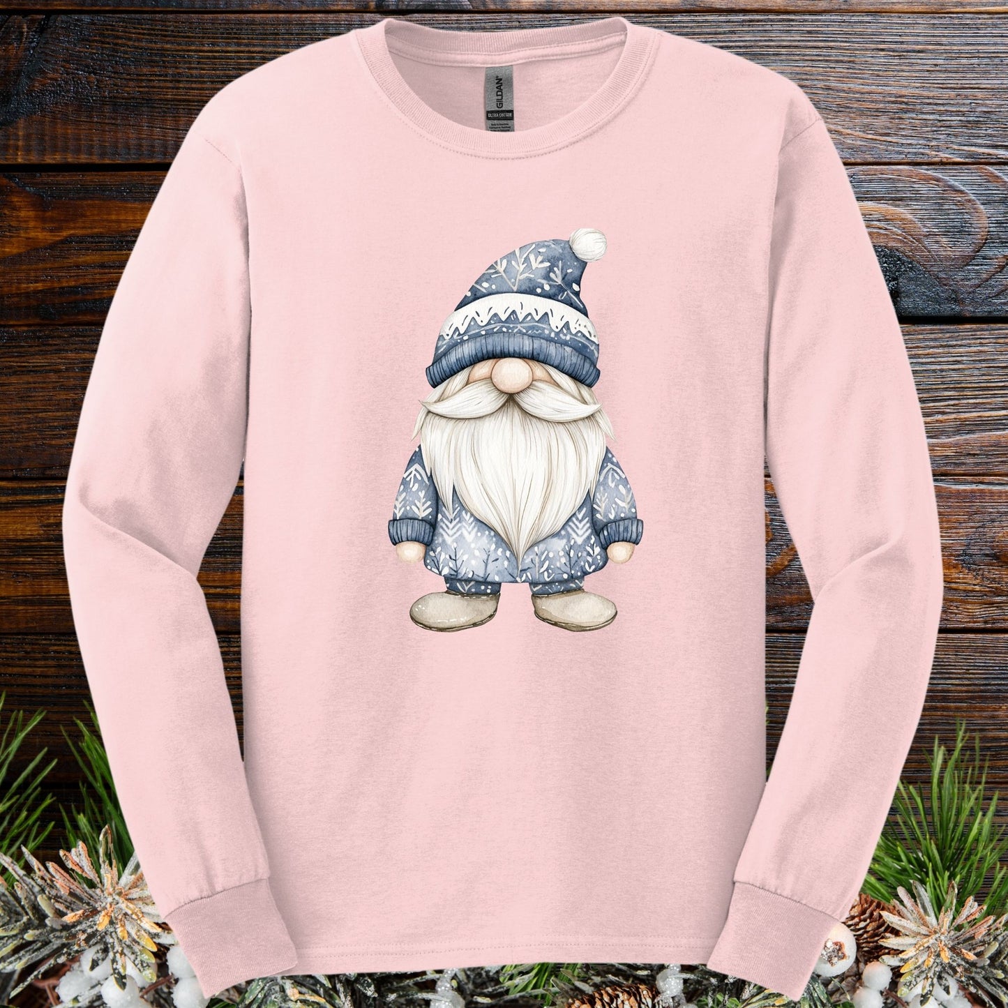 Light pink long sleeve tee with a hand-illustrated blue Nordic gnome design on the chest.
