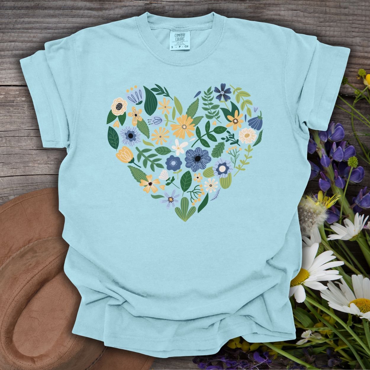 Chambray blue garment-dyed t-shirt with a heart-shaped bouquet of blue, yellow, and navy floral designs.