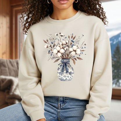 Beige sweatshirt with a blue and white chinoiserie vase holding cotton bolls, dried leaves, and berries.