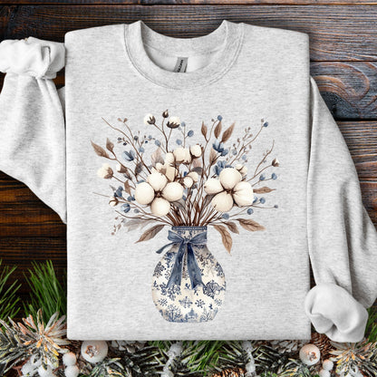 Ash S sweatshirt with a blue and white chinoiserie vase holding a winter bouquet of cotton bolls and dried leaves.