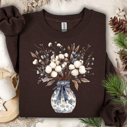 Dark chocolate sweatshirt with a blue and white winter floral bouquet in a chinoiserie vase.