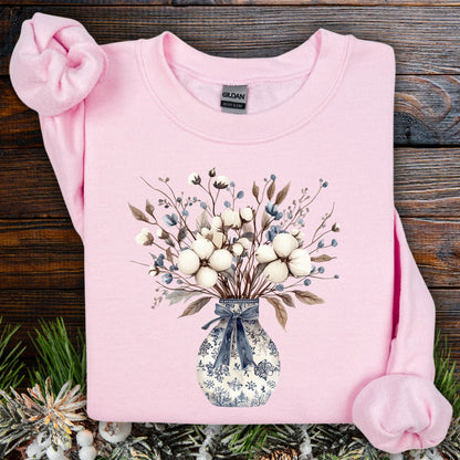 Light pink Gildan sweatshirt with a blue and white winter floral bouquet design featuring cotton bolls.