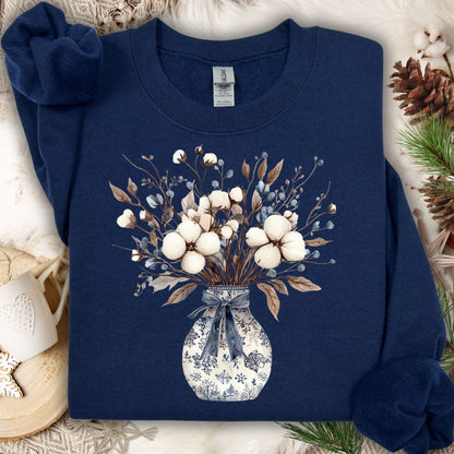 Navy S sweatshirt with a blue and white chinoiserie vase holding a winter bouquet of cotton bolls and berries.