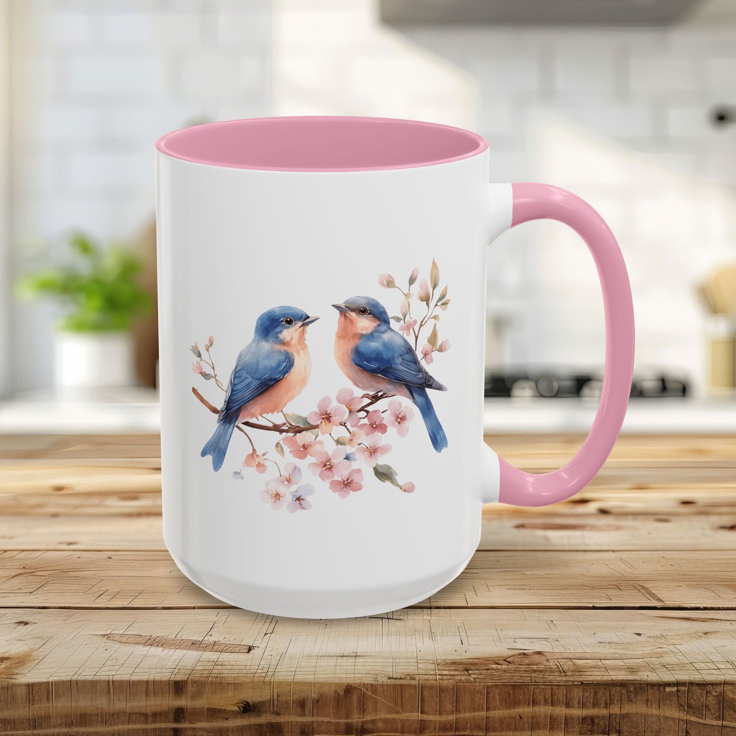 15oz ceramic mug with watercolor bluebirds on cherry blossoms, pink interior and handle.