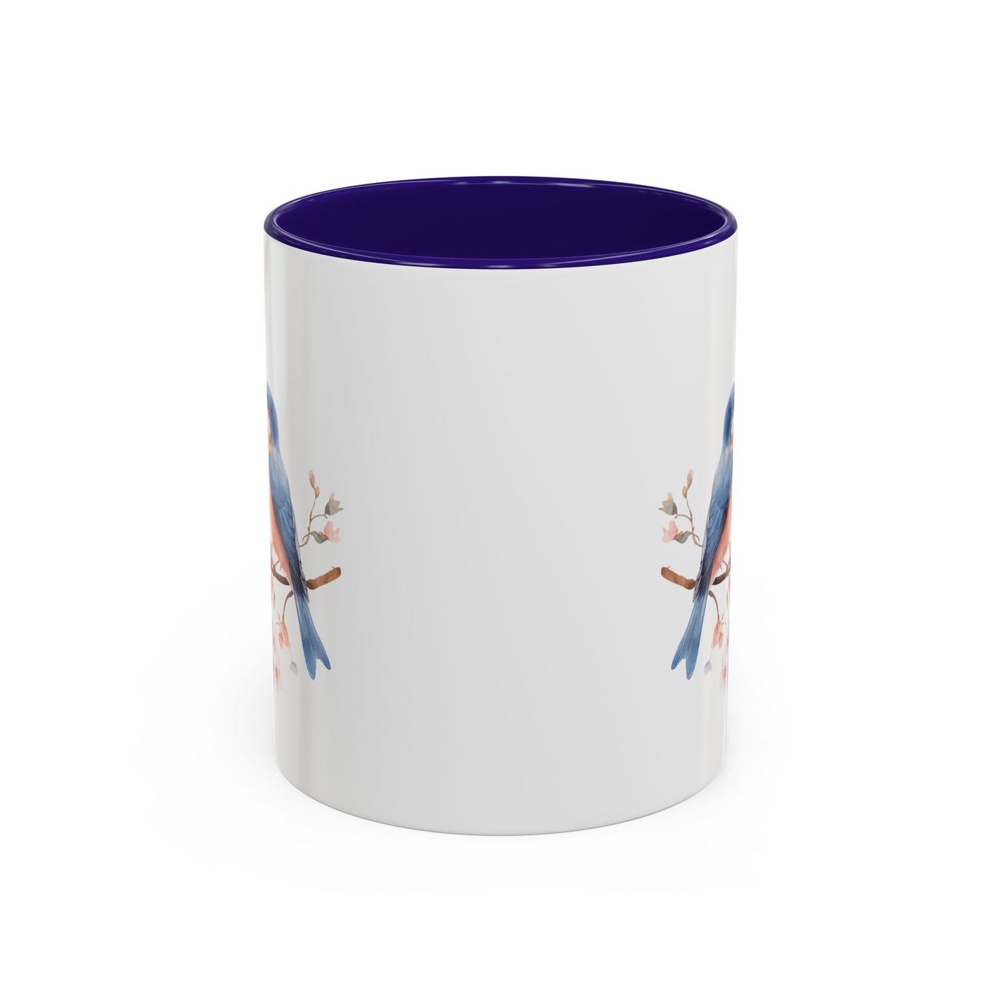 White ceramic mug with bluebirds on cherry blossoms, purple interior, and C-shaped handle.