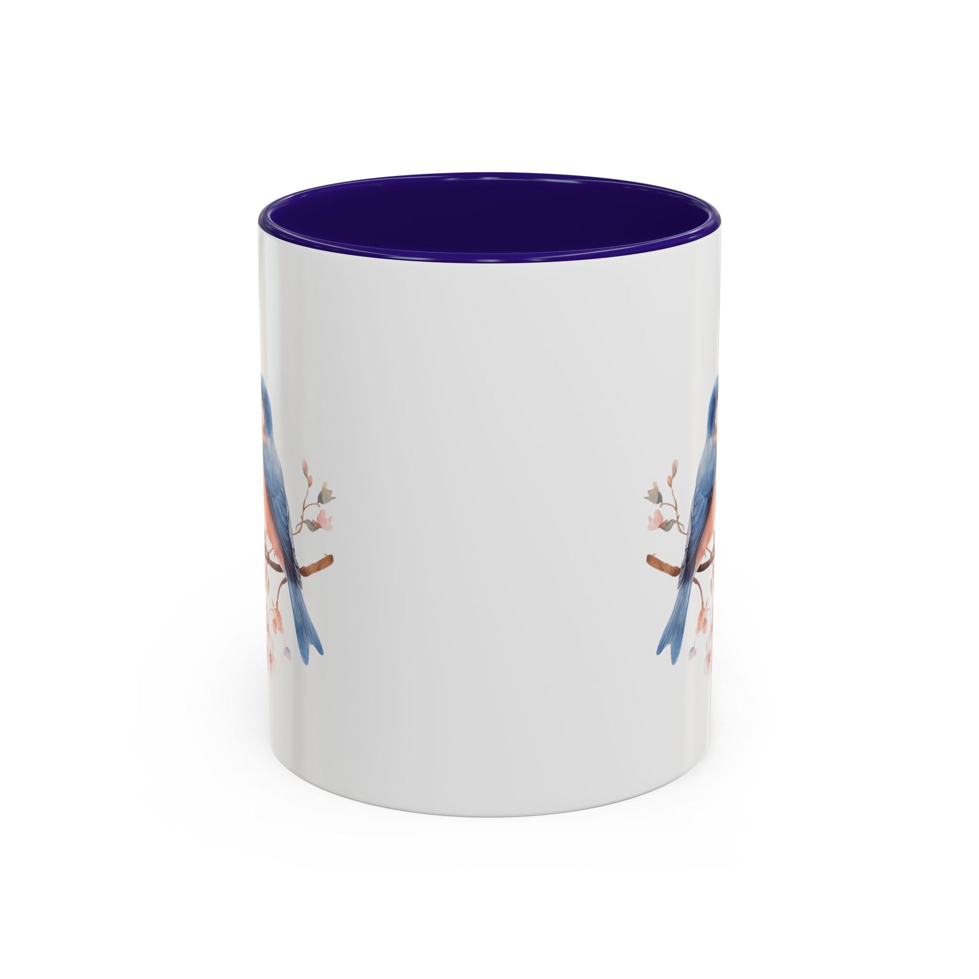 White ceramic mug with bluebirds on cherry blossoms, purple interior, and C-shaped handle.