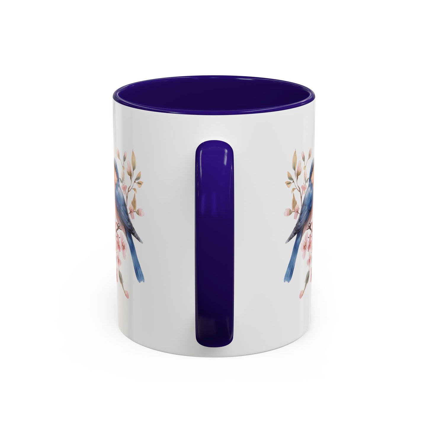 White ceramic mug with bluebirds on cherry blossoms, purple interior and handle.