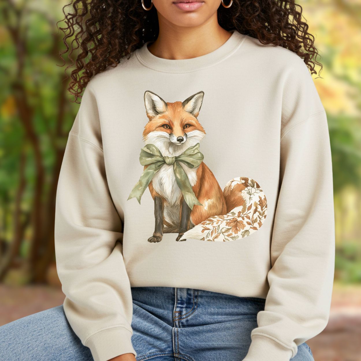 Boho autumn fox sweatshirt with green bow and fall botanicals on tail, worn by a woman.