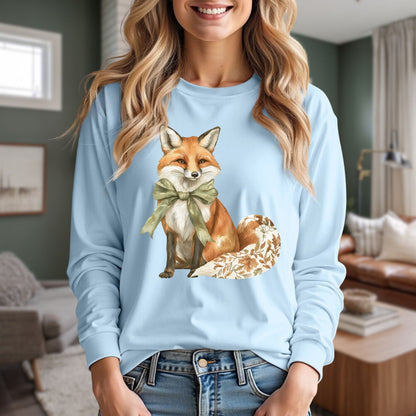 Light blue long sleeve tee with a watercolor fox, green bow, and autumn botanical tail.