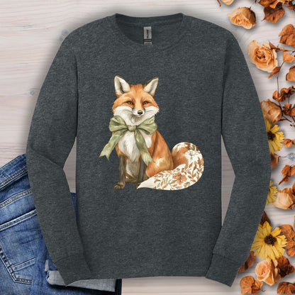 Dark Heather long sleeve tee with a watercolor fox wearing a green bow and autumn botanicals on its tail.