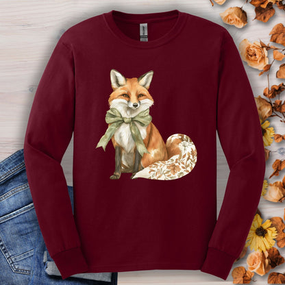 Maroon Gildan long sleeve tee with watercolor fox, green bow, and autumn leaf tail design.