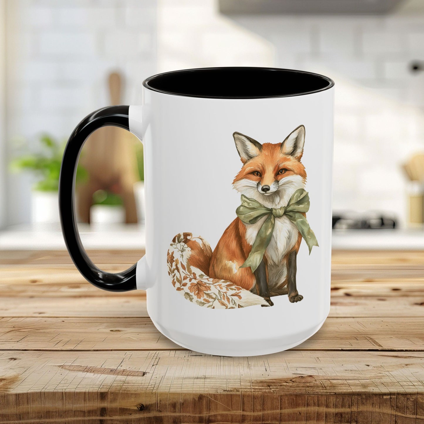 White ceramic mug with a watercolor fox wearing a green bow and a black handle and interior.