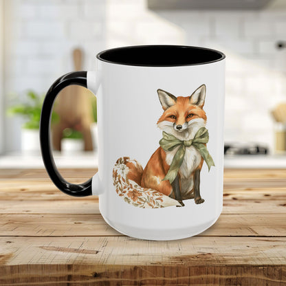 White ceramic mug with a watercolor fox wearing a green bow and a black handle and interior.