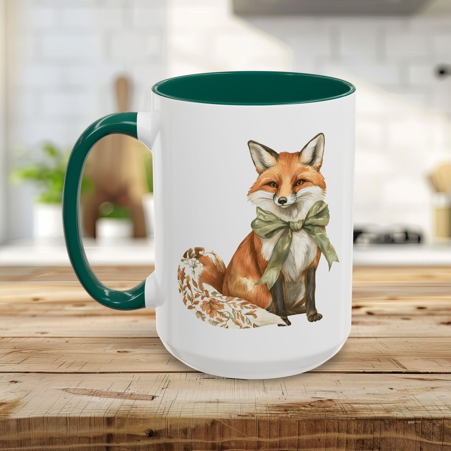 White ceramic mug with a watercolor fox wearing a green bow, featuring a matching green handle and interior.