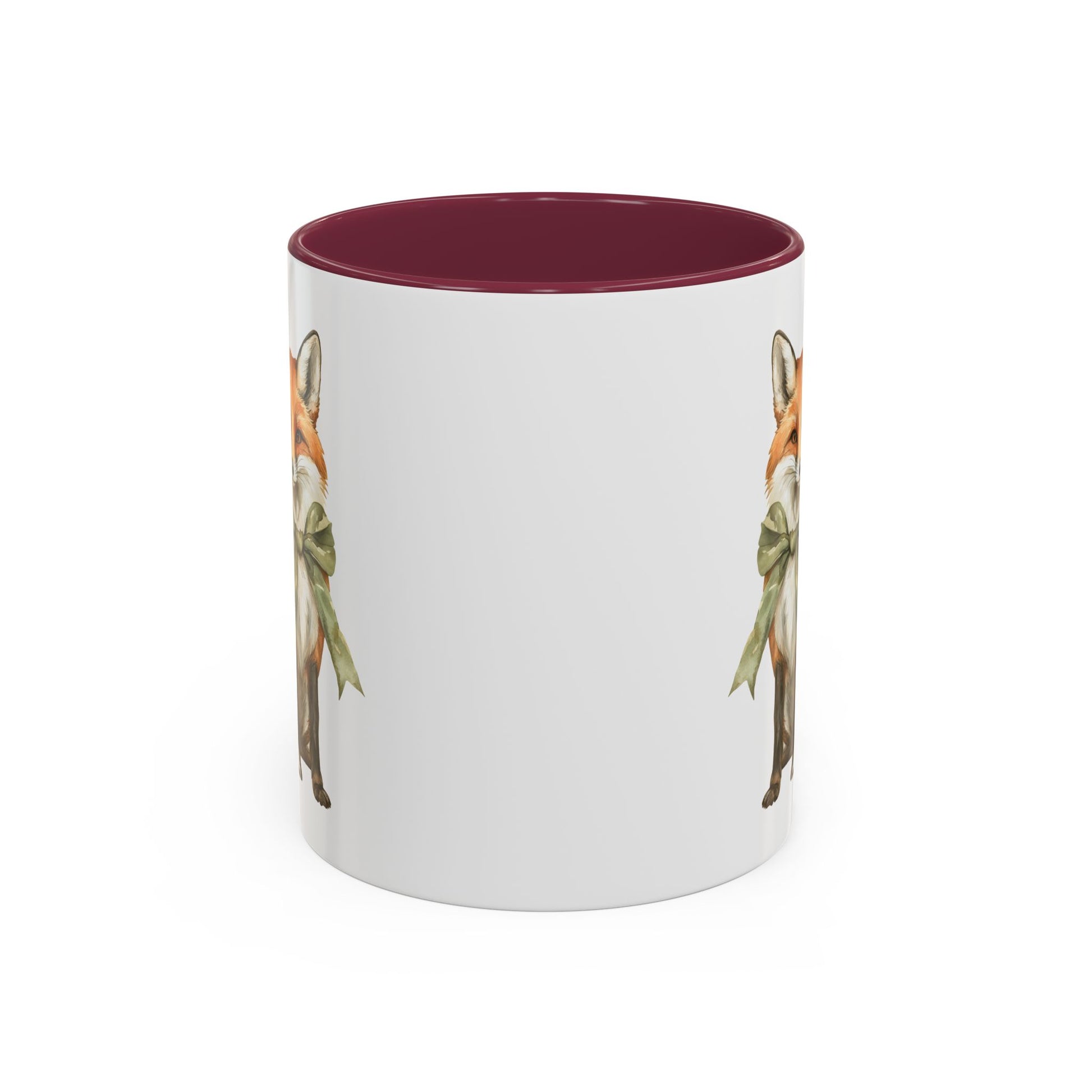 White ceramic mug with a watercolor fox wearing a green bow, featuring a burgundy interior and handle.