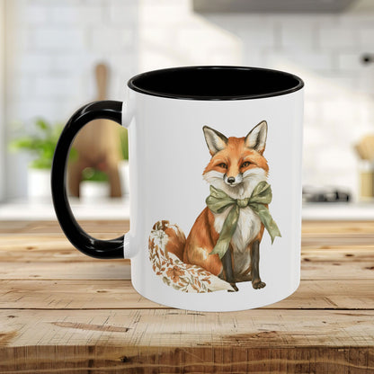 Boho autumn fox ceramic mug with a green bow, black handle, and interior, on a wooden table.