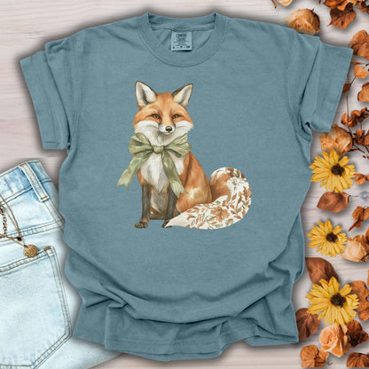 Ice Blue S t-shirt with a watercolor autumn fox wearing a sage green bow and a leaf-patterned tail.