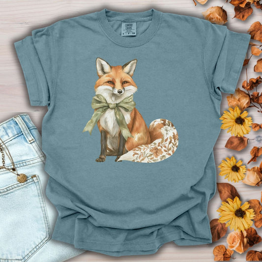 Ice Blue S t-shirt with a watercolor autumn fox wearing a sage green bow and a leaf-patterned tail.