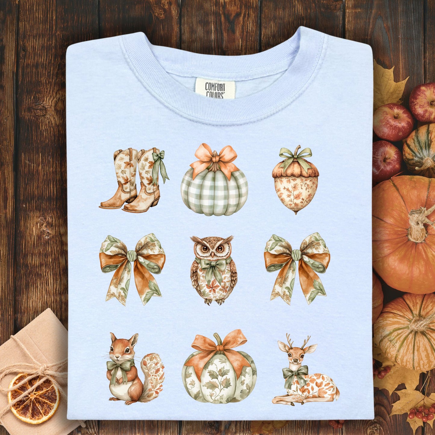 Hydrangea blue cotton t-shirt with boho fall artwork: boots, pumpkins, acorn, owl, squirrel, and deer.