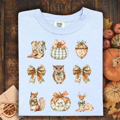 Hydrangea blue cotton t-shirt with boho fall artwork: boots, pumpkins, acorn, owl, squirrel, and deer.